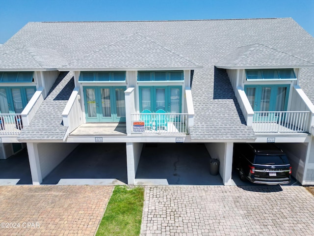 101 S 39th St Unit C, Mexico Beach, FL 32456 - view of side of property featuring a shingled roof and french doors