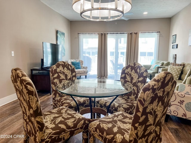 101 S 39th St Unit C, Mexico Beach, FL 32456 - dining space with healthy amount of natural light, dark wood-type flooring, a chandelier, and baseboards