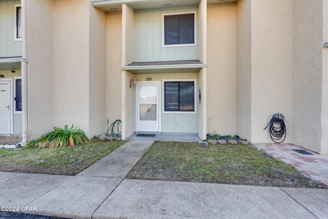 entrance to property with a yard