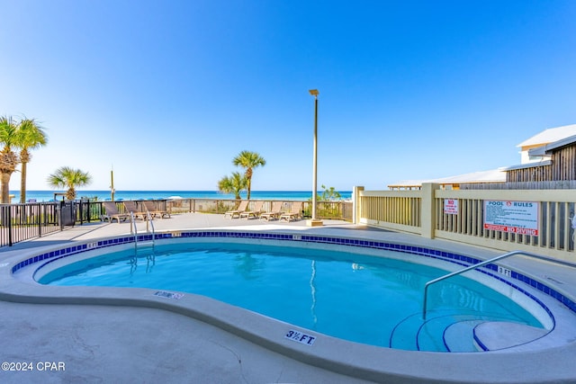 view of pool with a water view