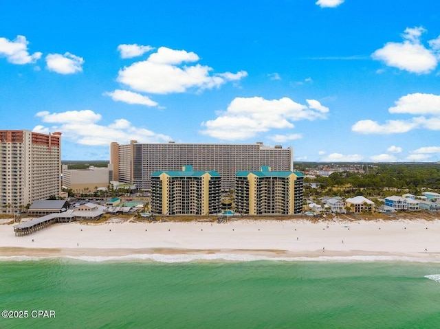 bird's eye view with a water view and a beach view