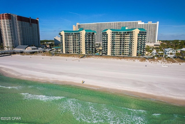 view of building exterior with a water view and a view of the beach