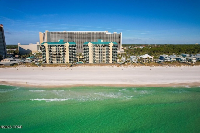 birds eye view of property with a beach view and a water view