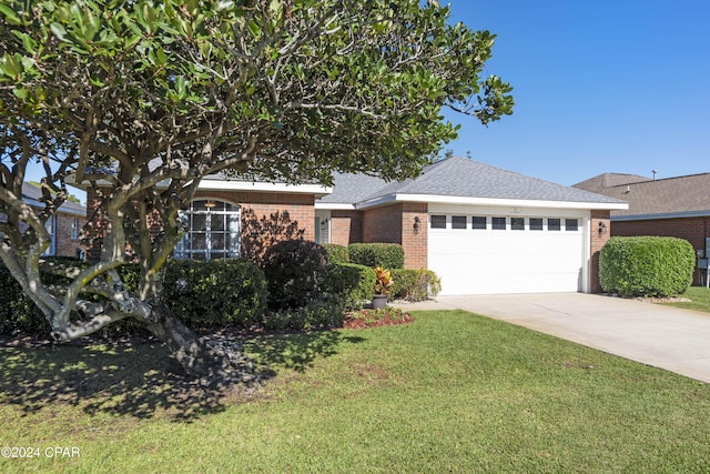 view of front of property featuring a garage and a front yard