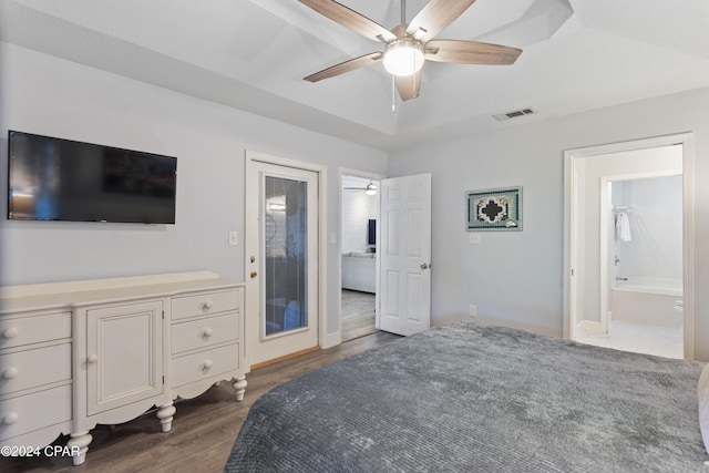 bedroom with ensuite bathroom, ceiling fan, and dark hardwood / wood-style floors