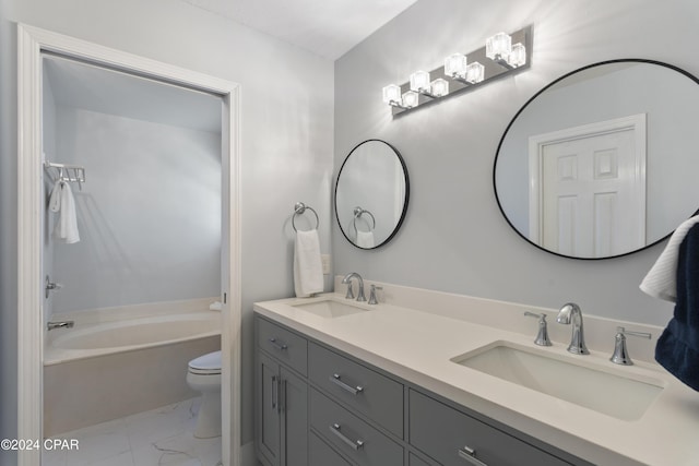 bathroom featuring toilet, vanity, and a bathtub