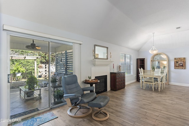 sitting room with hardwood / wood-style floors and lofted ceiling