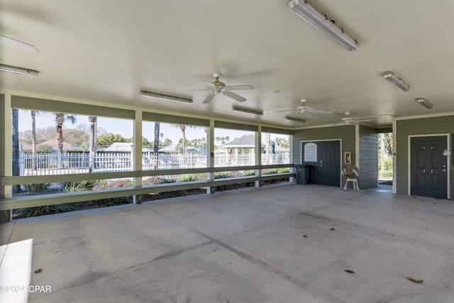 unfurnished sunroom with a water view and ceiling fan