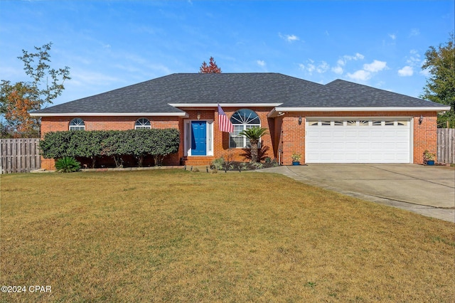 ranch-style home with a garage and a front yard