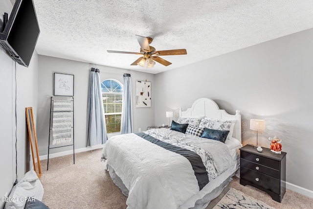 carpeted bedroom featuring a textured ceiling and ceiling fan