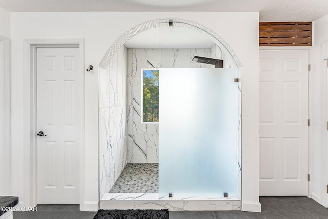 bathroom with a tile shower