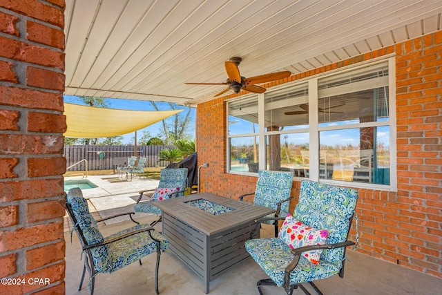 view of patio / terrace with ceiling fan and an outdoor fire pit