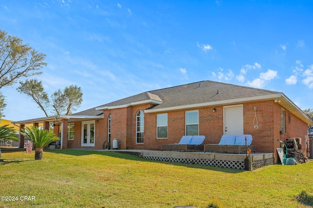 back of property featuring a lawn