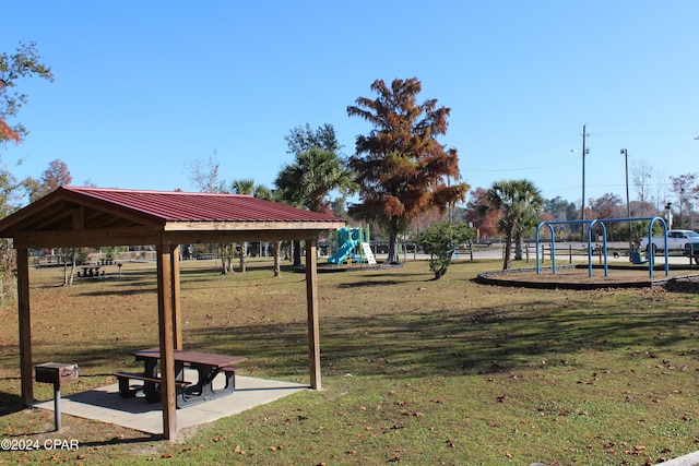 view of community with a gazebo, a lawn, and a playground