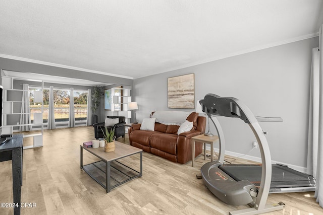 living area with light wood-type flooring, crown molding, and baseboards