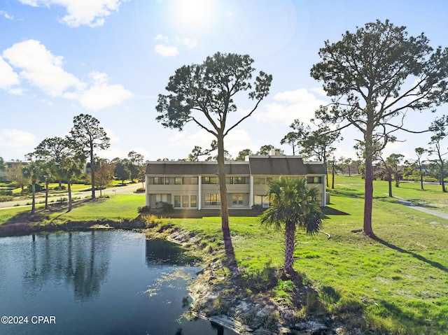 exterior space with a water view and a lawn