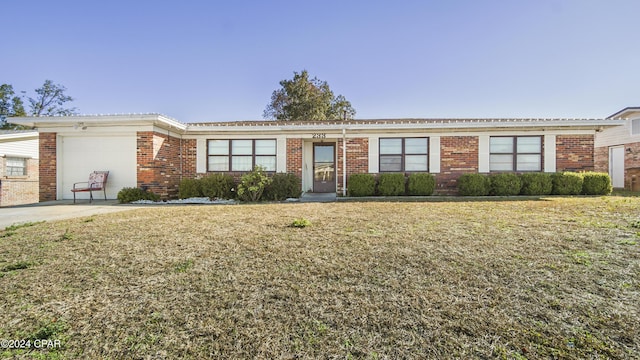 single story home featuring a garage and a front lawn