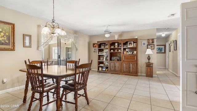 tiled dining space featuring ceiling fan with notable chandelier