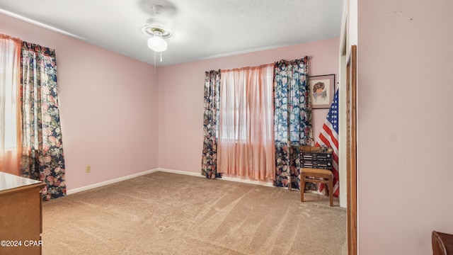 interior space with ceiling fan