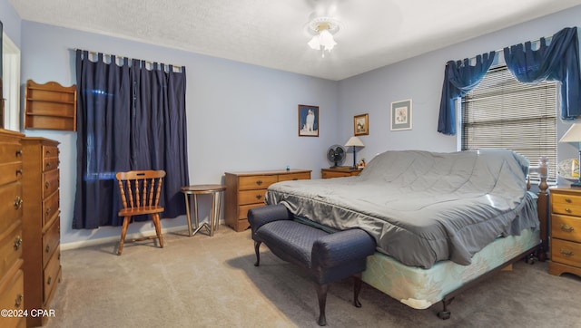 carpeted bedroom with a textured ceiling