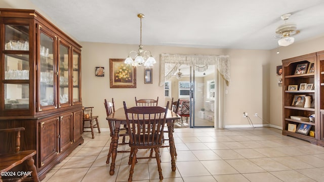 tiled dining room with ceiling fan with notable chandelier