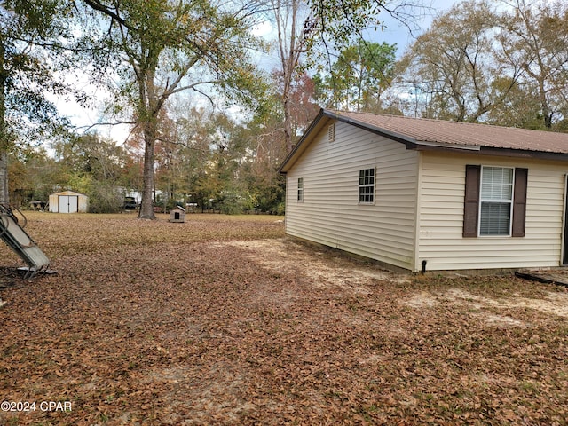 view of home's exterior with a storage unit