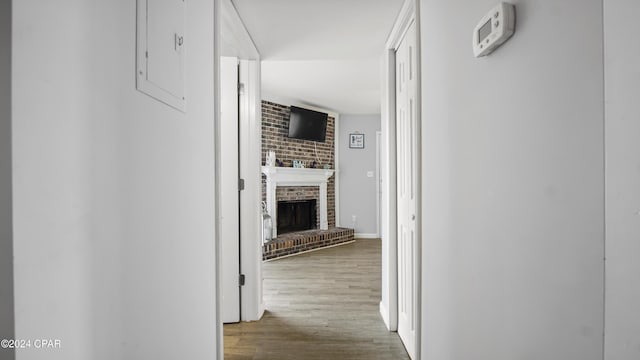 corridor featuring hardwood / wood-style floors and electric panel