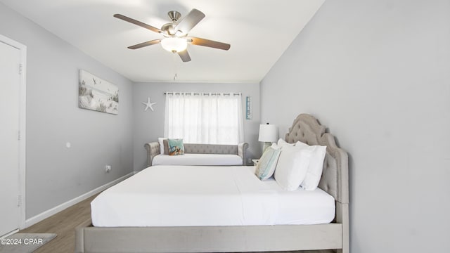 bedroom with ceiling fan and hardwood / wood-style flooring