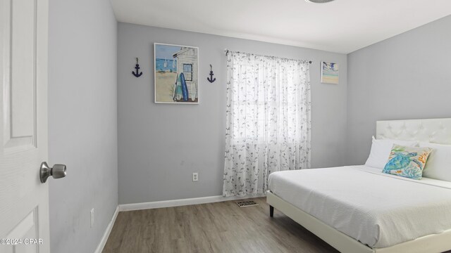 bedroom featuring wood-type flooring