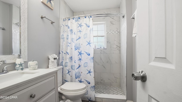 bathroom with curtained shower, vanity, and toilet