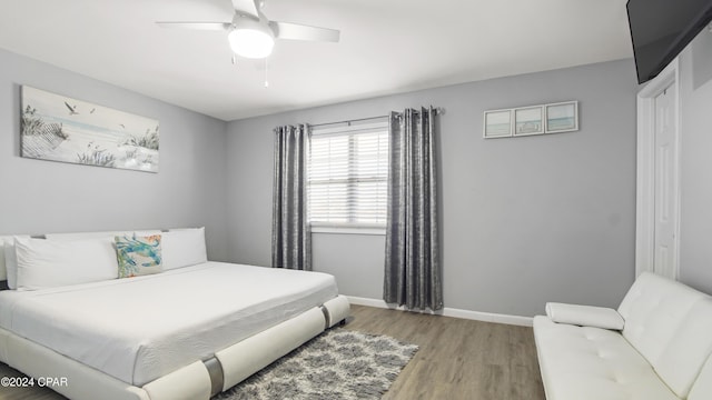 bedroom with ceiling fan and light hardwood / wood-style floors