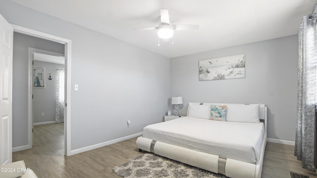 bedroom featuring hardwood / wood-style flooring and ceiling fan