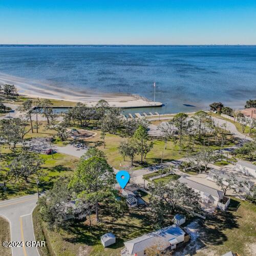 birds eye view of property with a water view and a view of the beach