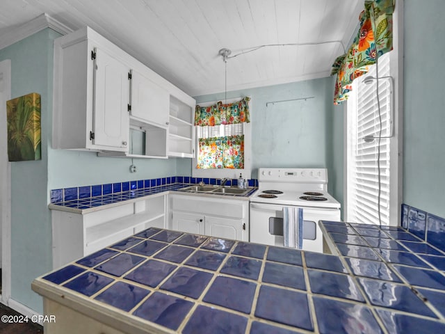 kitchen featuring tile countertops, white range with electric cooktop, white cabinetry, and sink