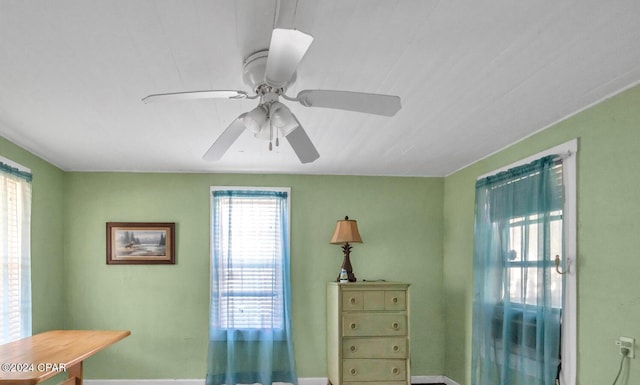 living area with plenty of natural light and ceiling fan