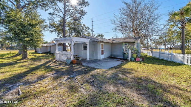 rear view of property with a lawn, a patio area, and a pergola