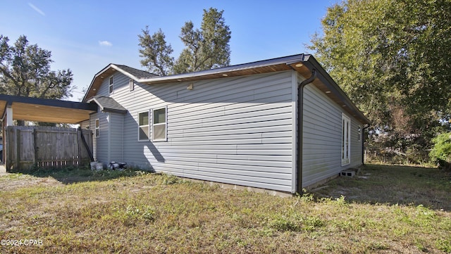 view of side of home with a lawn