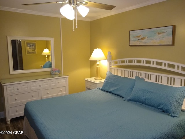 bedroom with ceiling fan, crown molding, and dark wood-type flooring