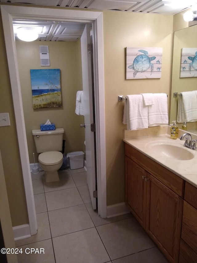 bathroom featuring toilet, vanity, and tile patterned floors