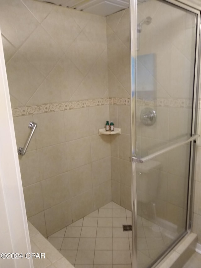 bathroom featuring a shower with shower door