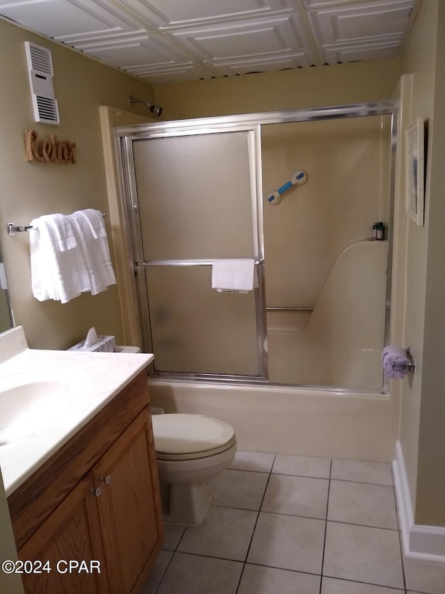 full bathroom with tile patterned flooring, vanity, toilet, and enclosed tub / shower combo