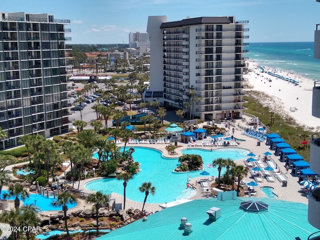 view of pool with a view of the beach and a water view