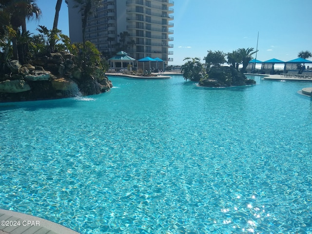 view of swimming pool with pool water feature