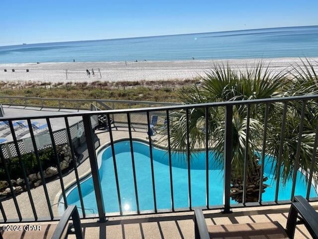 balcony with a water view and a beach view