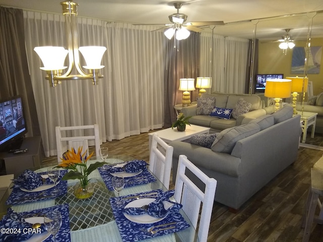 living room with wood-type flooring and ceiling fan with notable chandelier