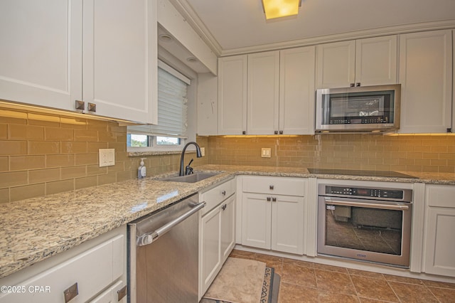 kitchen with sink, stainless steel appliances, white cabinets, and backsplash