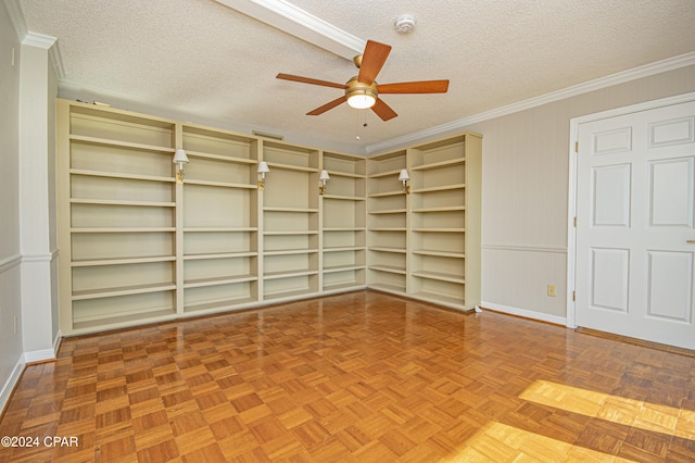 empty room with a textured ceiling, ceiling fan, parquet flooring, and built in shelves