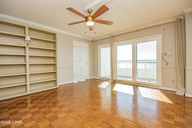 spare room with ceiling fan, parquet flooring, crown molding, and a textured ceiling