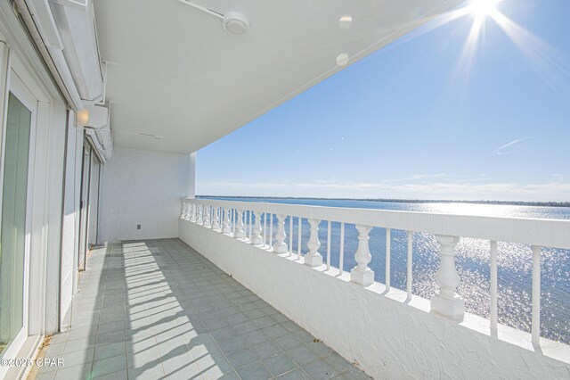 balcony featuring a beach view and a water view