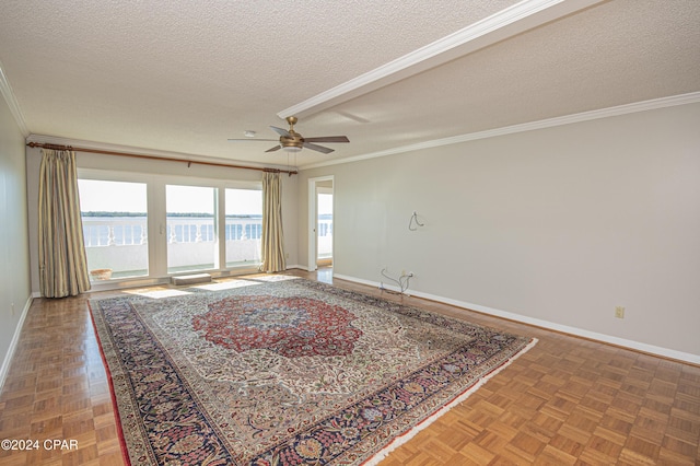 interior space with a textured ceiling, parquet flooring, and a water view